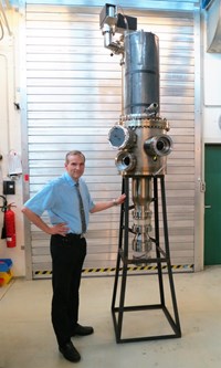 John Jelonnek, who is in charge of the KIT development program for the gyrotron, stands next to the 1 MW short-pulse prototype. (Click to view larger version...)