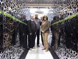 The CEA-F4E CSC team standing between a section of the Helios supercomputer, from left to right: Jacques David, François Robin, Jacques Noé (CEA) and Susana Clement Lorenzo (F4E). (Click to view larger version...)