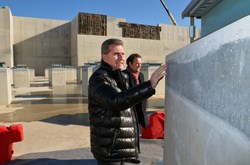 Commissioner Oettinger, deliberately walking ahead of the group of officials, took a solitary stroll through the 493 plinths and seismic pads, closely examining the concrete finish of the columns and the rubber and steel bearings. (Click to view larger version...)