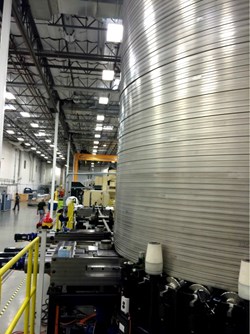 The first part of the central solenoid winding station is a de-spooler, shown here unwinding material for the mock-up coil. Photo: US ITER (Click to view larger version...)