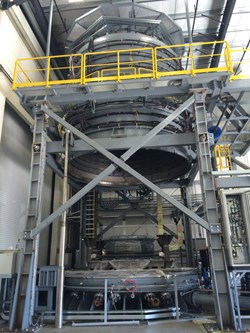 The reaction heat treatment furnace is shown opened up; the upper portion will descend when a module is inside. Photo: US ITER (Click to view larger version...)