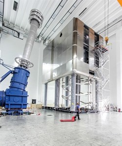 Standing on eight legs, six metres overhead, the high-voltage deck of the MITICA testbed is an electrically insulated box that hosts the power supplies for the neutral beam injector's ion source. © Consorzio RFX (Click to view larger version...)