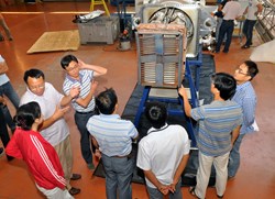 ITER personnel from China gather around the ITER-like antenna as it is beinng packed before shipment to Hefei via Shanghai. (Click to view larger version...)