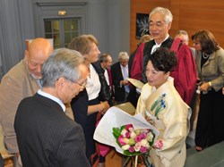 ''I cannot let this moment pass,'' said Director-General Motojima, ''without thanking my dear wife Kaoru who has been always at my side with constant support and encouragement.'' Mrs Motojima, in traditional kimono, is seen here in conversation with Japanese Consul General Danai Tsukhara. (Click to view larger version...)