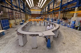 A radial plate (here at CNIM before packing and loading operations began) is a ten-ton, 8.5 x 15 metre, D-shaped stainless steel structure with grooves machined on both sides, into which insulated superconductor cable is inserted. (Click to view larger version...)
