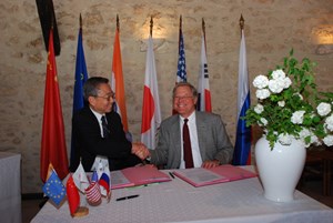 Ikeda san and Ned Sauthoff, Head of the US Project Office, signing the procurement for the electron cyclotron transmission line. (Click to view larger version...)