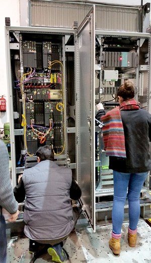 The electronic components had been aged in previous tests to simulate a situation in which the seismic event occurs near or at the end of ITER's lifetime. In this photo, experts carry out visual inspections. (Click to view larger version...)