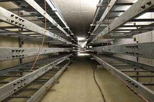 Cable trays line the two sides of the electrical service tunnel like bunk beds. ''You could walk these tunnels from the cooling towers on the east side of the worksite to just outside the grid yard on the west side,'' says Laurent Schmieder. (Click to view larger version...)