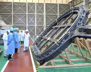 Director-General Osamu Motojima (centre, in blue) leads a delegation that includes Ken Blackler and Mitsunori Kondoh from the ITER Organization, Joo-Shik Bak from ITER Korea, and Ned Sauthoff from US ITER. Pictured, a mockup of a section of toroidal field coil case (Toshiba, Keihin Product Operations, Yokohama, Japan). (Click to view larger version...)