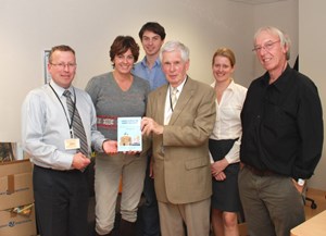 Mike Forrest handing over a copy of his book to the ITER Newsline team. (Click to view larger version...)