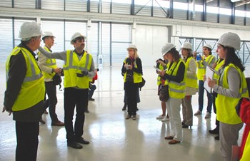 The two-day program included a visit of the worksite and presentations on the status of the project, plasma physics, tritium cycle, etc. Here, civil engineer Mahaboob Basha Syed gives a tour of the Poloidal Field Coils Winding Facility. (Click to view larger version...)
