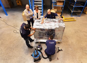 ITER Coil Instrumentation engineer Felix Rodriguez-Mateos and DAHER's Ines Bollini (left) watch as dozens of components are being taped, wrapped into thick heat/humidity insulation aluminium foil and placed into a robust wooden crate. (Click to view larger version...)