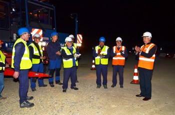 The convoy arrived on the ITER site at 5:25 a.m. Standing with ITER Director-General Motojima (far right) are members of the DAHER team, including the last-stage driver Karl Kilian (blue jacket); François Genevey, chief of ITER Project at DAHER (third from right) and Bernard Bon, head of convoy (second from right). (Click to view larger version...)
