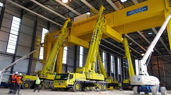 The crane stands 18 metres high and travel on rails fixed to the floor, in order to cover the entire length of the workshop during the assembly process. (Click to view larger version...)