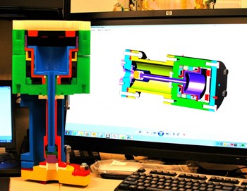 A 3D printed version of a fast gas valve for the disruption mitigation system. The 3D design is shown on the computer screen in the background. Photo: US ITER (Click to view larger version...)