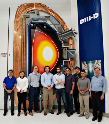 Real-time error field correction was demonstrated by a multi-institutional research team that included scientists from General Atomics, Oak Ridge Associated Universities, the University of California-San Diego, and Columbia University. Note the ''X point'' in the upper part of the D-shaped plasma in the background poster: DIII-D is one of the few tomakaks that can be operated with upper, lower or multiple ''X points.'' (Click to view larger version...)