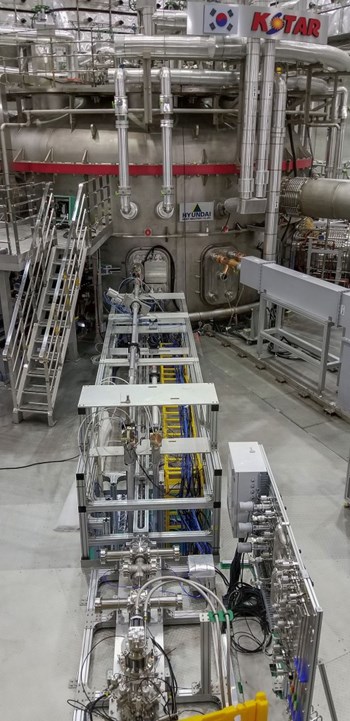 One of the two injectors at KSTAR—the pellets are formed in the cryogenic chamber visible in the foreground and are then injected into the plasma through a flight tube of more than 10 m in length. The gas distribution panel is visible on the right. Vacuum components also ensure that propellant gas that is used to release and accelerate the pellets is held back to not enter the plasma before the pellet. A microwave cavity measures the velocity and mass of the injected pellet. (Click to view larger version...)