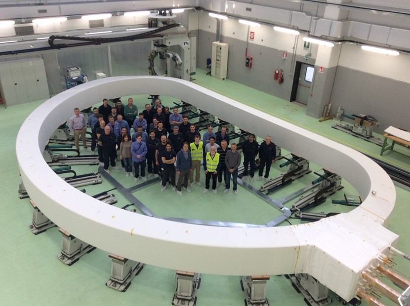 A giant magnet ... and a giant step forward for ITER. Representatives from the European Domestic Agency, the ITER Organization and contractors stand inside of the first inner winding pack of an ITER toroidal field coil. (Click to view larger version...)