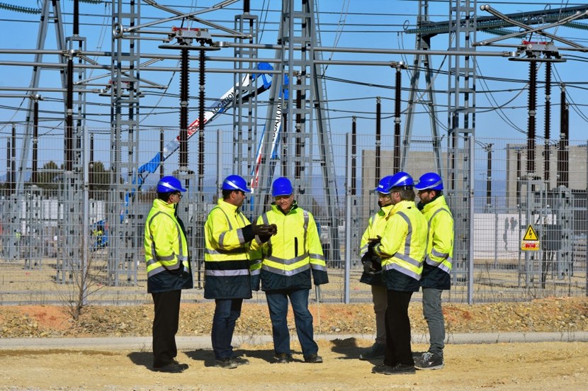 ITER head of Plant Engineering Sergio Orlandi (centre) and the ITER ''electricians''—head of division Ivone Benfatto and section leader Joël Hourtoule, along with Jeremy Sanna and Marco Olivier—stand at the edge of the switchyard as operations unfold. Also present is head of Communications Laban Coblentz. (Click to view larger version...)