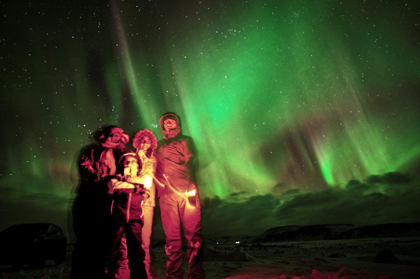 Sébastien and his family in Iceland, under the thin, luminescent drapes of Iceland's Northern Lights—''an incredibly moving experience...'' (Click to view larger version...)