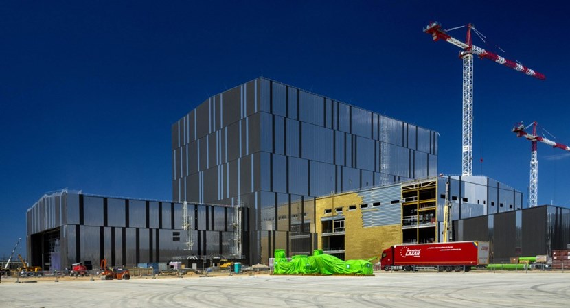 Originally planned for installation inside the Assembly Hall, equipment for the electron and ion cyclotron external heating systems (power supplies and generators) now has a three-storey building of its own. Located adjacent to the emblematic 60-metre-tall Assembly Hall, the structure is in the last stages of completion, as insulation and cladding is installed on the facades and finishing works are underway inside. As a red delivery truck passes in front of the building, the elements for the first large sector sub-assembly tool wait under their green wrapping for installation in the Assembly Building. (Click to view larger version...)