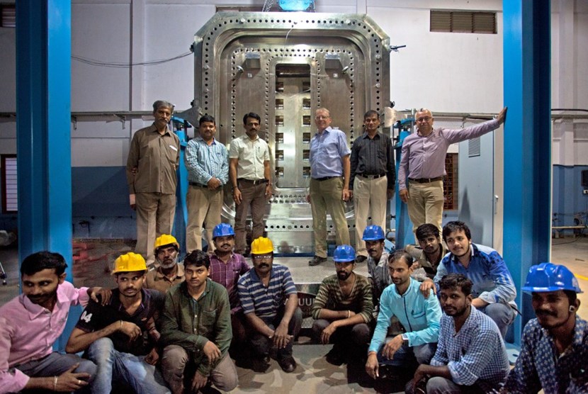 The team in celebratory mood after the completion of the test rig. This full-size replica of the largest of the equatorial ports has been designed to test the vacuum sealing. (Click to view larger version...)