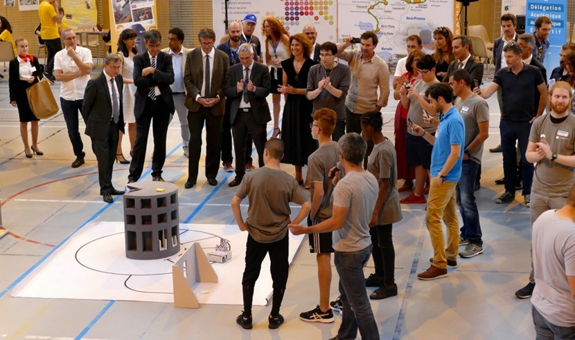 ITER supporters applaud the successful robot in a Transport challenge demonstration. (Click to view larger version...)