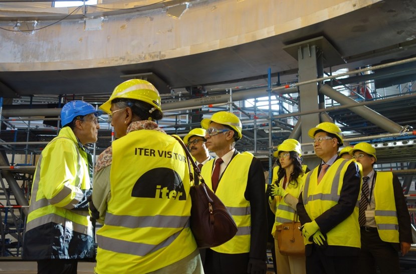 At the end of the second day, the ITER Director-General proposed a visit on site. One group of delegates can be seen here standing on the floor of the cryostat base, with the rim of the base in the background. (Click to view larger version...)