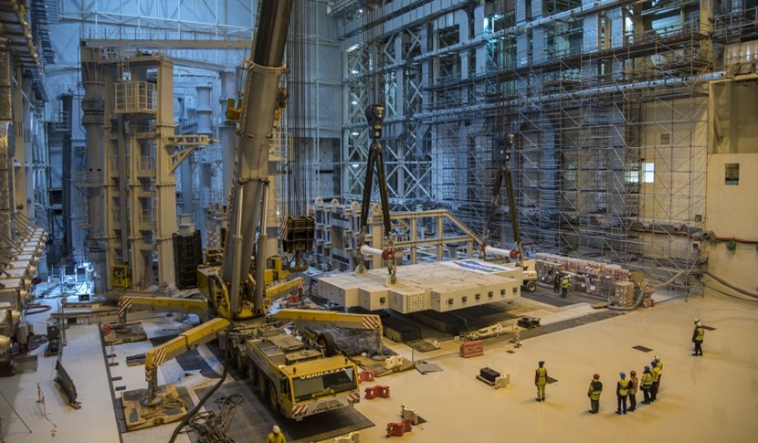 The 360-tonne megalith is lowered to the Assembly Hall floor. After six months hooked up first to one, then the other, of the sector sub-assembly tools (left), the test loads will be stored in laydown areas until called for use to commission the upending tool. (Click to view larger version...)