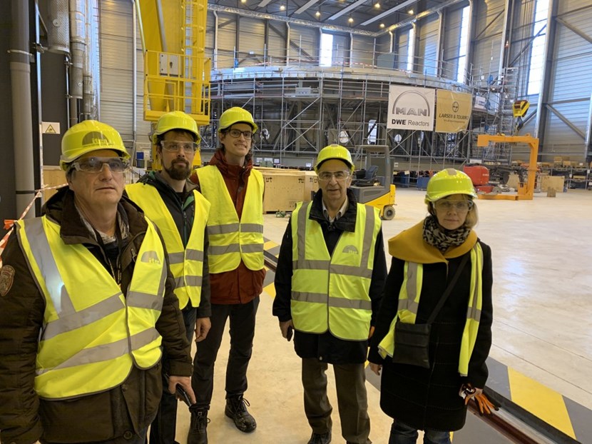 During a meeting at ITER, Scientist Fellows from the Divertor and SOL simulation group tour the Cryostat Workshop. In the background: the 1,250-tonne cryostat base that is being readied for transfer to the Tokamak pit. (Click to view larger version...)
