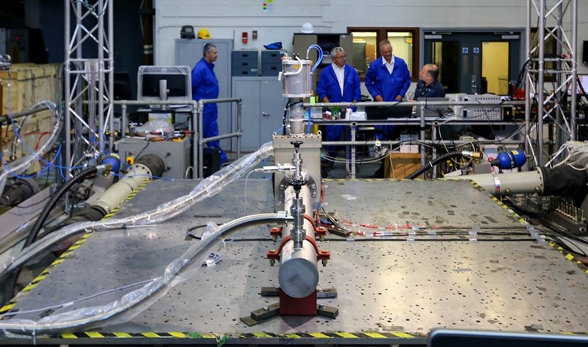 A DN 160 all-metal vacuum valve on the shaker table. In the background, from left to right: David Laugier, Eamonn Quinn and Graeme Vine from ITER, and Chris Stone from Element. (Click to view larger version...)