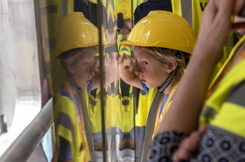 Younger people have the advantage! They get to work their way right up to the plexiglass that separates the port cell corridor from the impressive Tokamak pit. You can almost imagine the plasma whizzing around the central column. (Click to view larger version...)