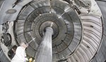 A researcher takes an upward view of the interior of NSTX, shown with the centre column. Copyright for all three photos: Princeton Plasma Physics Lab.