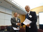 ITER Director-General Osamu Motojima shaking hands with Luo Delong, head of ITER China, after having signed the Procurement Arrangement for ITER's pulsed power electrical network, which will supply alternating current (AC) power to the machine's superconducting coils and its heating and current drives. This mighty power source will be procured by China.
