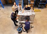 ITER Coil Instrumentation engineer Felix Rodriguez-Mateos and DAHER's Ines Bollini (left) watch as dozens of components are being taped, wrapped into thick heat/humidity insulation aluminium foil and placed into a robust wooden crate.