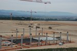 The columns for the Poloidal Field Coil Winding Facility are rising out the ground in the foreground, while the Tokamak Pit is taking shape in the background.
