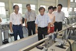A team from the Chinese Domestic Agency, led by Director Luo Delong (centre), witnesses the welding of the dummy conductor.