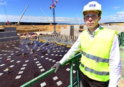 F4E project manager Laurent Schmieder (Division for site, buildings and power supplies) stands above the Tokamak Seismic Pit where concrete pouring on the next-level slab is scheduled to begin in August. (Click to view larger version...)