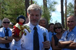 Deputy Director-General Gary Johnson explained where the money for the presents came from: the doll had served as piggybank for all the euros that people had had to donate for showing up late to the project's weekly project progress meeting. (Click to view larger version...)