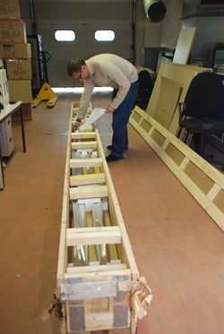 Arnaud Devred checking the first five-metre archival sample of toroidal field conductor being shipped from Japan to Cadarache. With each unit length produced, a sample has to be cut out and sent to Cadarche for storage. (Click to view larger version...)