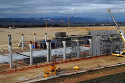 The concrete columns of the 250-metre-long Poloidal Field Coils Winding Facility are all up. Photo: F4E (Click to view larger version...)