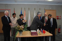 A moment of joy and relief: the Director-General of the ITER Organization, Osamu Motojima, and the Directors of all seven Domestic Agencies (US ITER not pictured) signing a Memorandum of Understanding for the use of a single Logistics Service Provider. (Click to view larger version...)