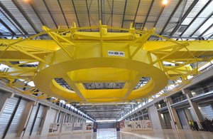 The bright yellow spreader beam, with its brackets radiating like golden rays, was a potent symbol of what ITER is about—harnessing the fusion fire that burns inside the Sun and stars. (Click to view larger version...)