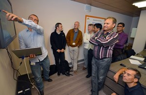 Jorge Villaneuva Cuenda, of the F4E CODAC team, demonstrates the integrated alarm system to IO CODAC staff and contractors. (Click to view larger version...)