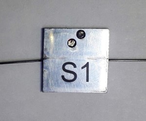 An example of an ITER FBG optical sensor that will be tested in Kazakhstan (size: 15 x 15 x 0.8 mm). A special technique has been developed in order to embed the specialized fibres in the sensor. (Click to view larger version...)