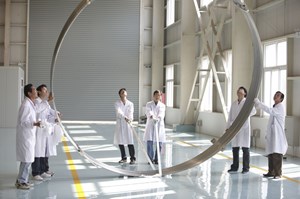 Without superconductivity, ITER would go from being a ''net energy positive'' machine to a ''net energy negative'' machine. Here, technicians at the Institute of Plasma Physics in Hefei, haul a model of ITER's superconducting correction coils. © Peter Ginter (Click to view larger version...)
