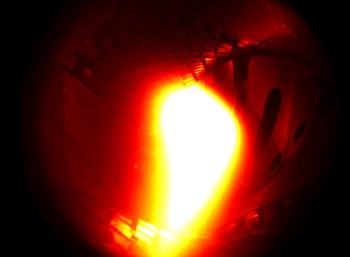 10 December 2015: Wendelstein 7-X achieves first plasma. The helium plasma reached a temperature of about one million degrees Celsius for one tenth of a second. Photo: IPP (coloured black-and-white photo) (Click to view larger version...)