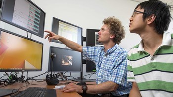 Matthew Hole (left) and Zhisong Qu are in the virtual control room for overseas fusion experiments at the Research School of Physics & Engineering (ANU College of Physical & Mathematical Sciences). Credit: Stuart Hay, ANU. (Click to view larger version...)