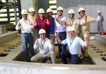 Nine people can easily stand in the cryostat opening for the torus cryopump housing. At the Larsen & Toubro factory in Hazira, ITER vacuum experts witnessed progress in the testing of the welds and in the manufacturing of the pedestal ring and the lower cylinder of the cryostat. In the first row, Eamonn Quinn (left) and Robert Pearce. (Click to view larger version...)