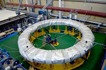 The first of eight winding packs for poloidal field coil #1 (PF1) undergoes epoxy impregnation at the Srednenevsky Shipbuilding Plant in Saint Petersburg, Russia. The resin—acting inside of a sealed mould and under the effect of heat—hardens the tape to bond each double pancake into a rigid assembly. (Click to view larger version...)